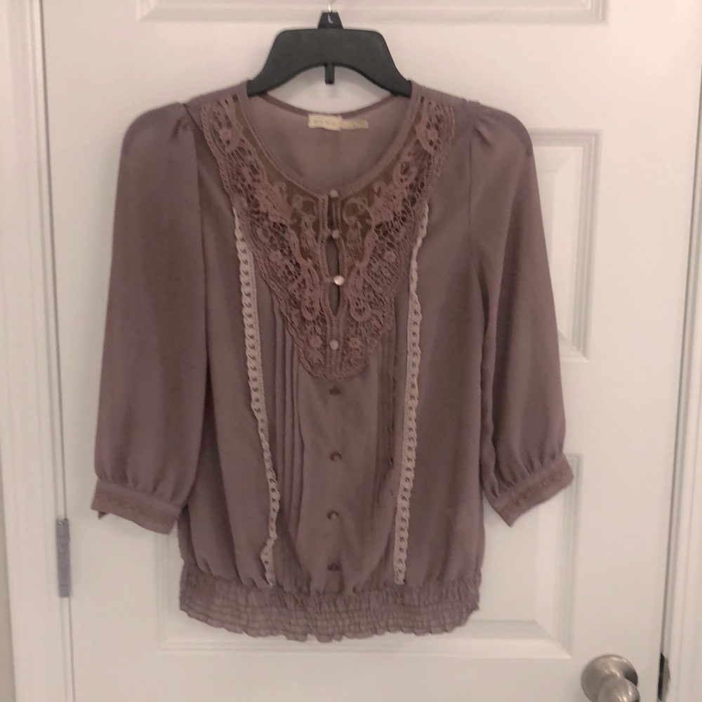 Lilac blouse with lacy adornments and buttons